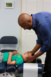 Chiropractic for ear infection, Dr. Emil Tompkins adjusting a child